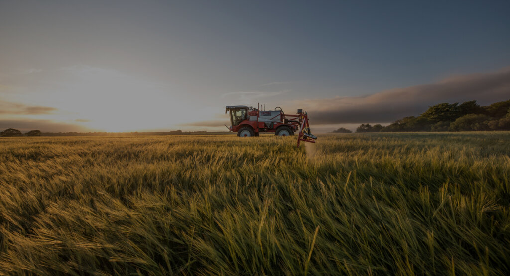 Ag Leader-equipped sprayer in a field at sunset